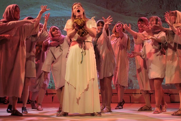 A woman who is showing how to improve a singing voice